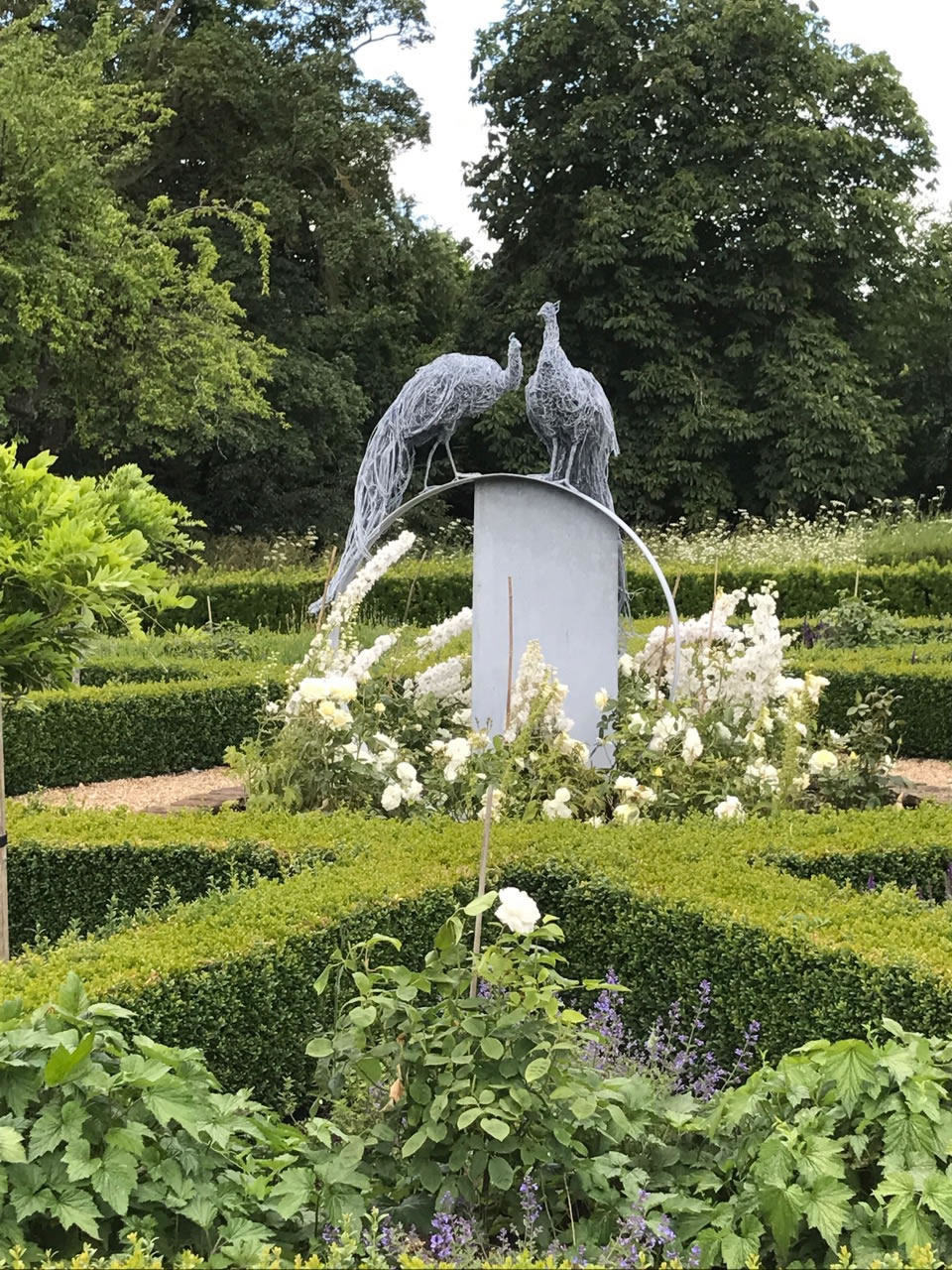 Peacock wire sculpture installed in a Cambridgeshire Garden